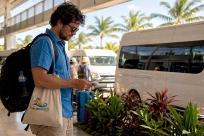 Shuttle vans and passenger with voucher at Cancun Airport