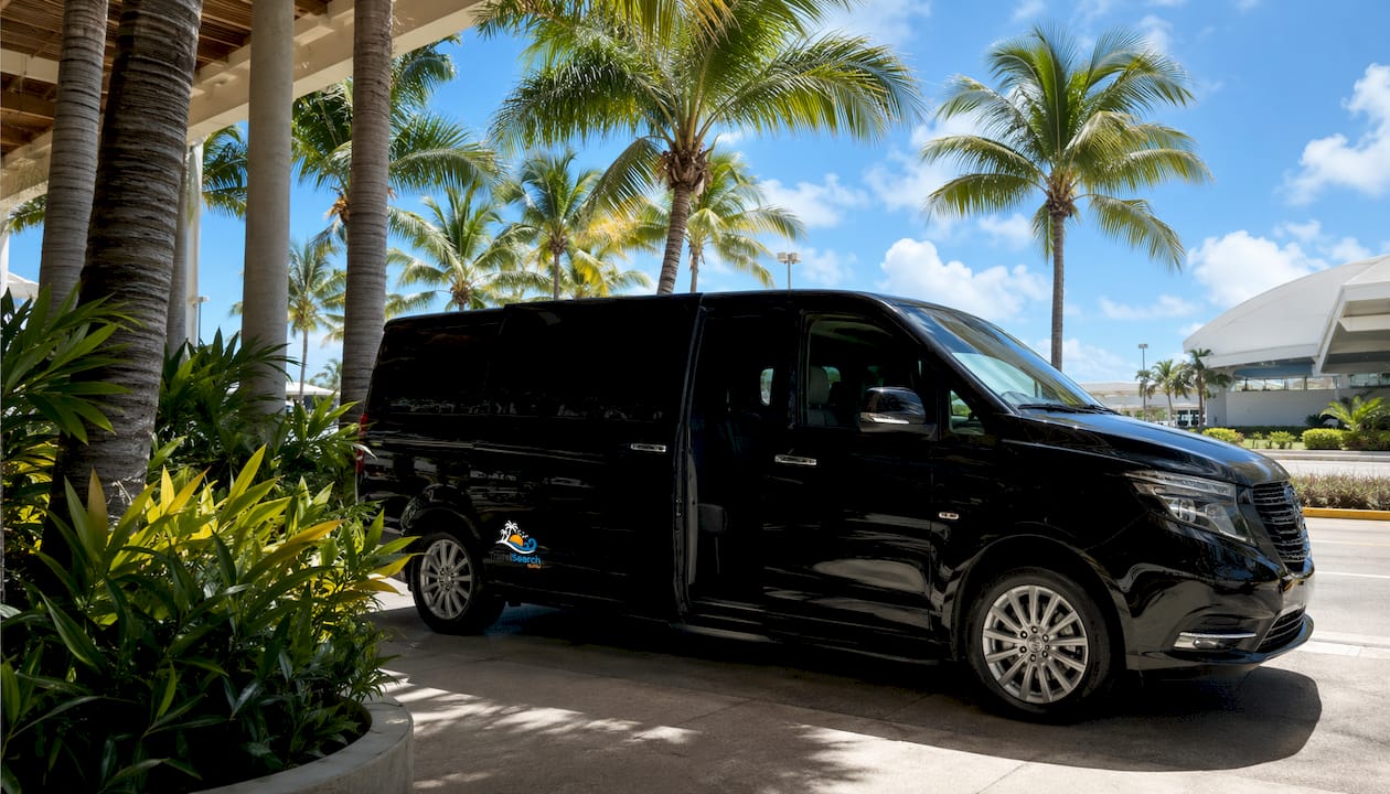 White private transfer van ready outside Cancun airport