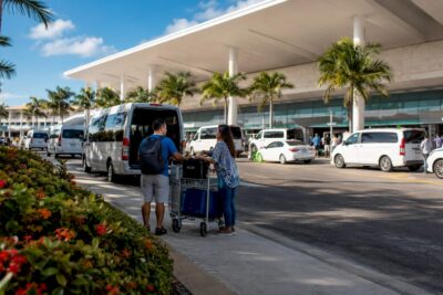 Main exterior of Cancun airport with transfer vehicles
