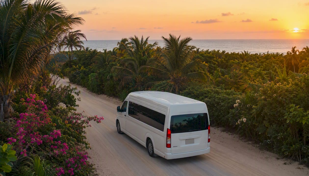 Cancún Group Transfer Prices: What You'll Pay in 2026 1 Shared shuttle bus on tropical road