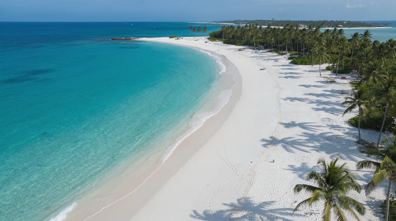 Planned Vacations: How to Turn Your Next Resort Getaway Into a Stress‑Free Escape 2 An aerial drone shot captures a stunning white sand Caribbean beach, bordered by vibrant turquoise waters and swaying palm trees, inviting travelers to plan their next vacation getaway. This picturesque destination offers a perfect setting for relaxation and adventure under the sun.